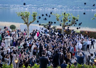 Students from the INSEEC business school tossing their toques in the air at the graduation ceremony